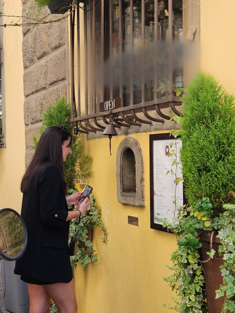 Local Florence travel tips: Drinking Chianti from a historic plague-era wine window.
Florence Wine Windows: Drinking Through Walls Guide