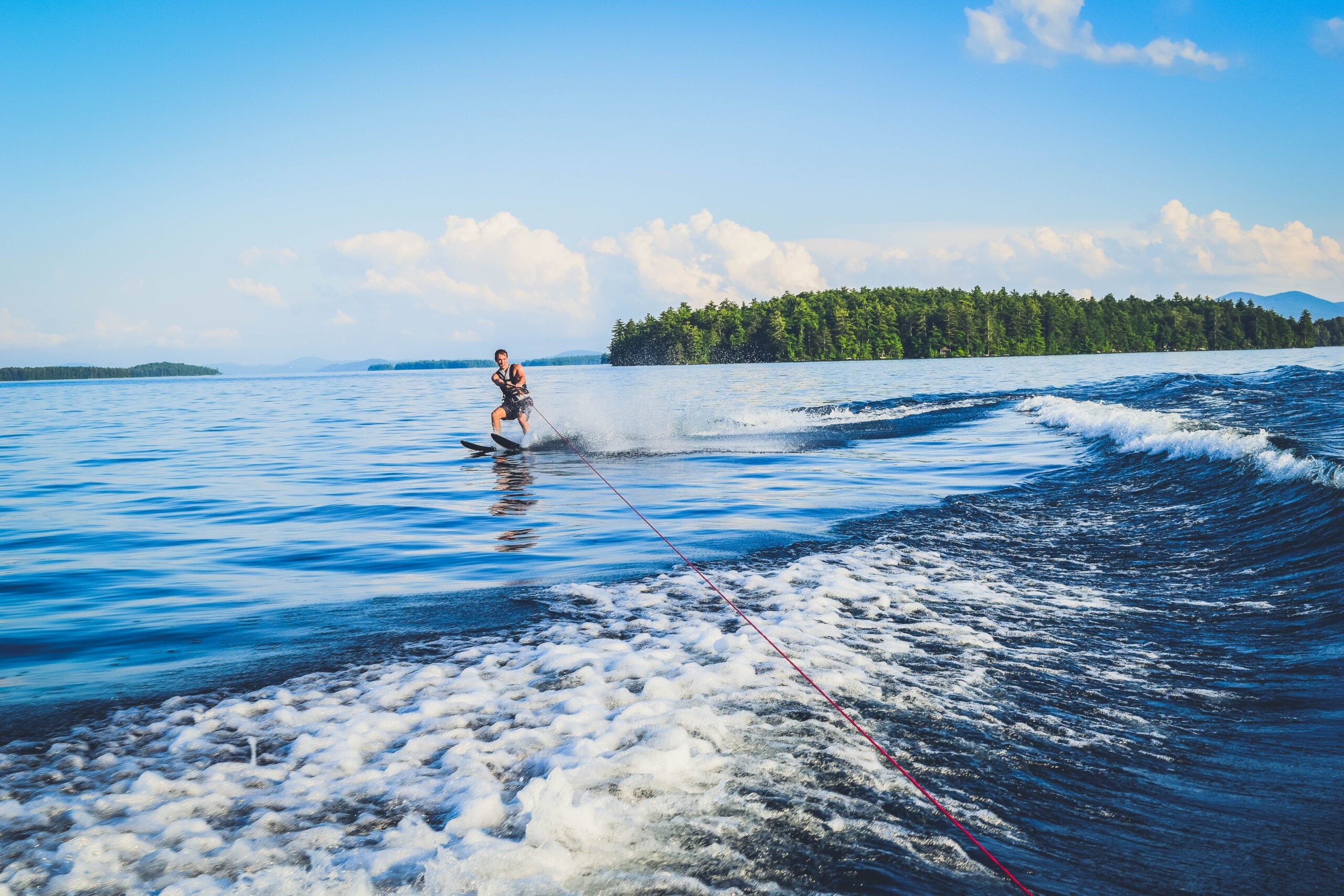 Lake Winnipesaukee_New Hampshire_Travel Guide_What to do_What to See_waterski_man_adventure_sport_water_nature_mountains