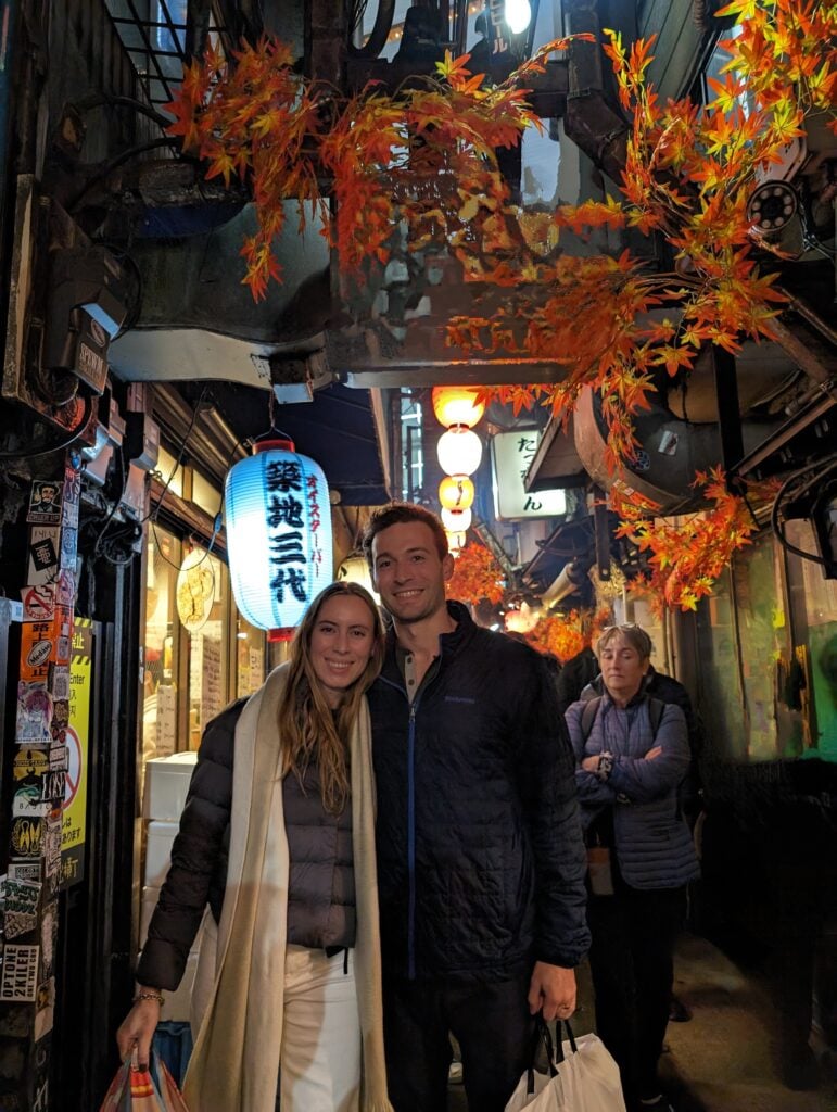 Smoky narrow stalls of Omoide Yokocho in Shinjuku, showing the 'Point and Eat' style of yakitori dining.