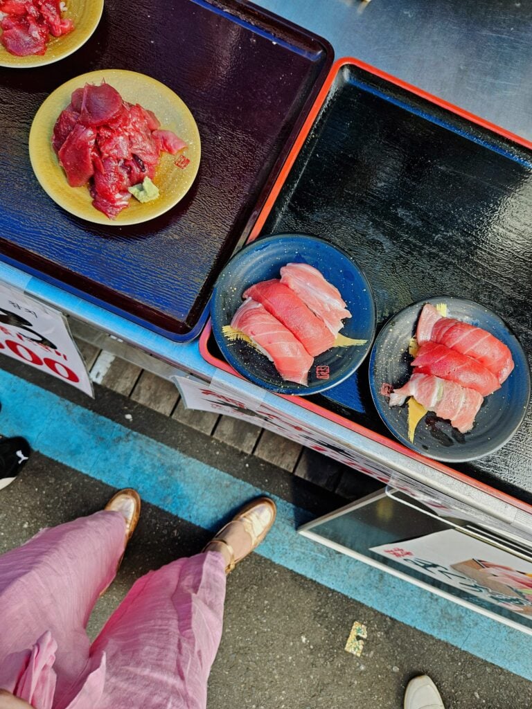 Street food stalls at Tsukiji Outer Market serving fresh seafood